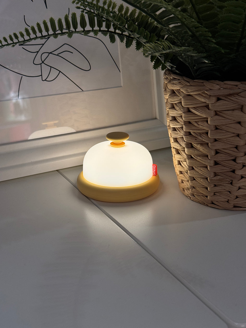 Cute bell looking night light on a counter.