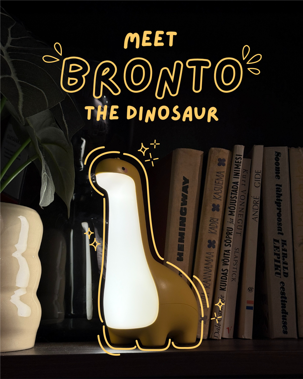 Dinosaur-shaped night light with 'Meet Bronto the Dinosaur' text on a dark background with books and a plant.