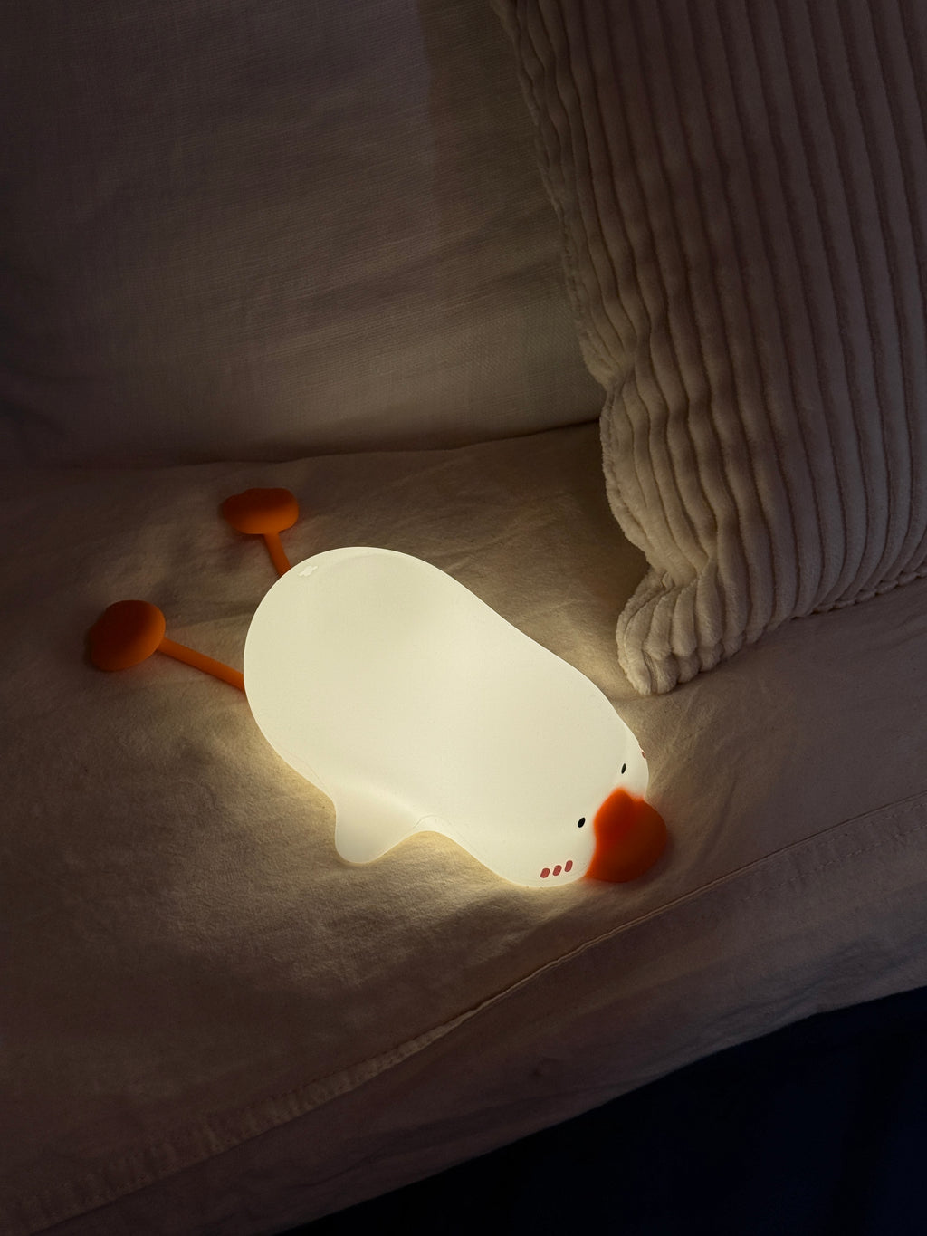Cute animal-shaped night light on a bed
