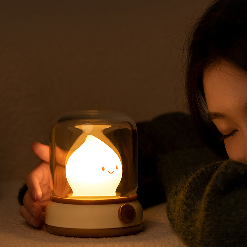 Person holding a glowing night light with a warm ambiance