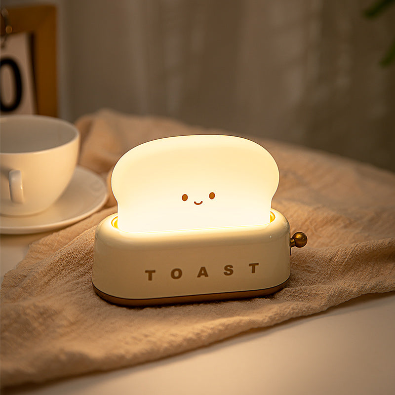 Toast-shaped night light on a table with a cup in the background