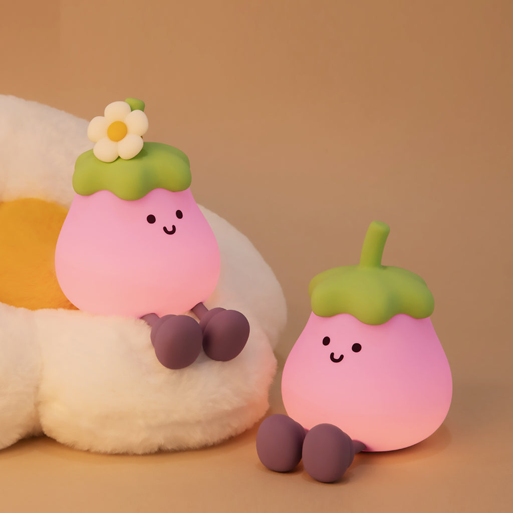 Two cute eggplant night lights on a beige background.